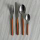 24 vintage stainless steel and orange plastic cutlery sets