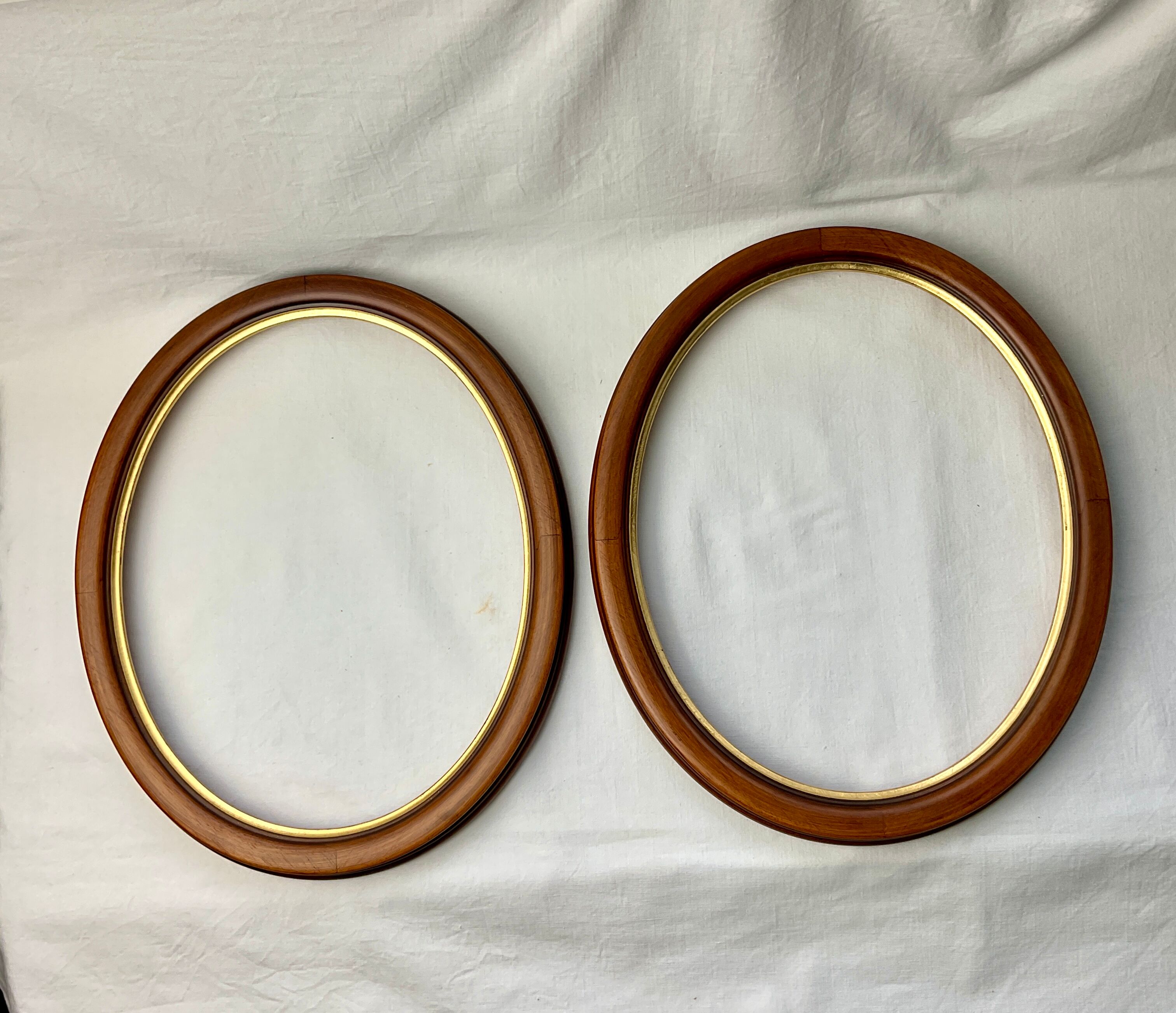 Pair of oval wooden frames with gilding