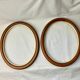 Pair of oval wooden frames with gilding