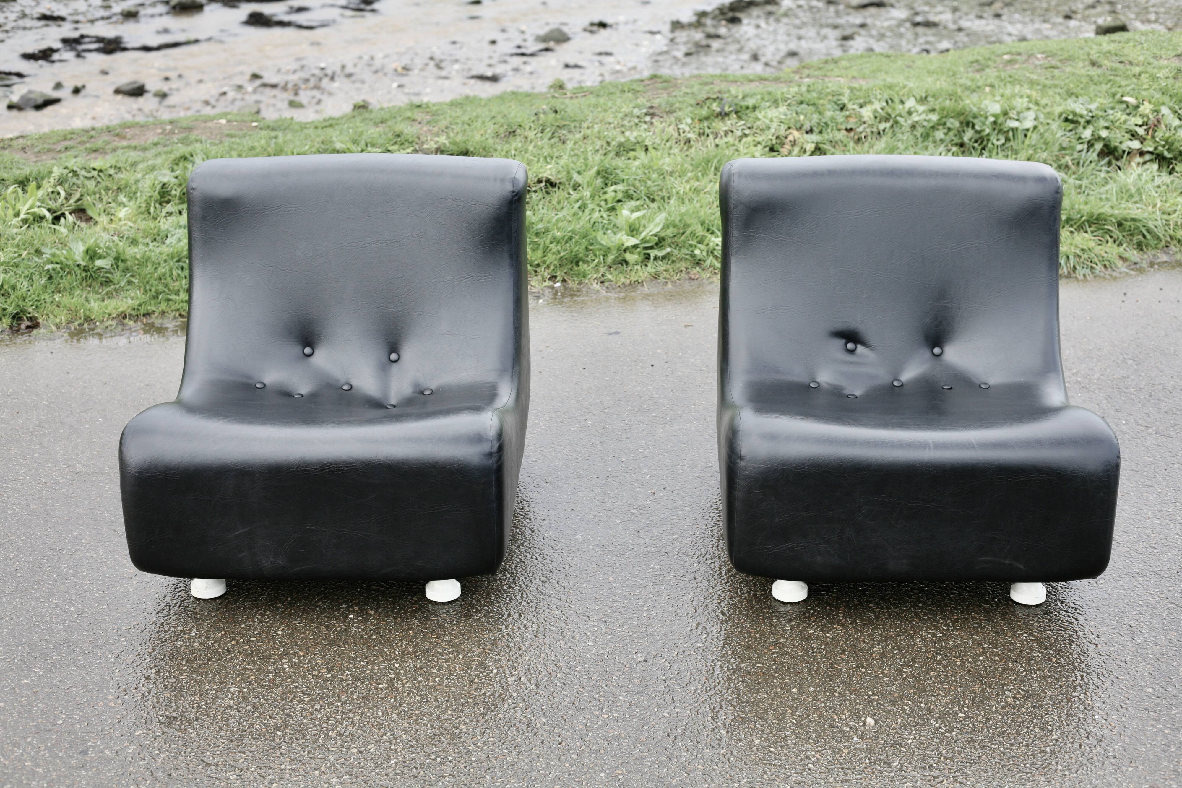 Pair of “space age” low chairs. Black faux leather. Circa 1970