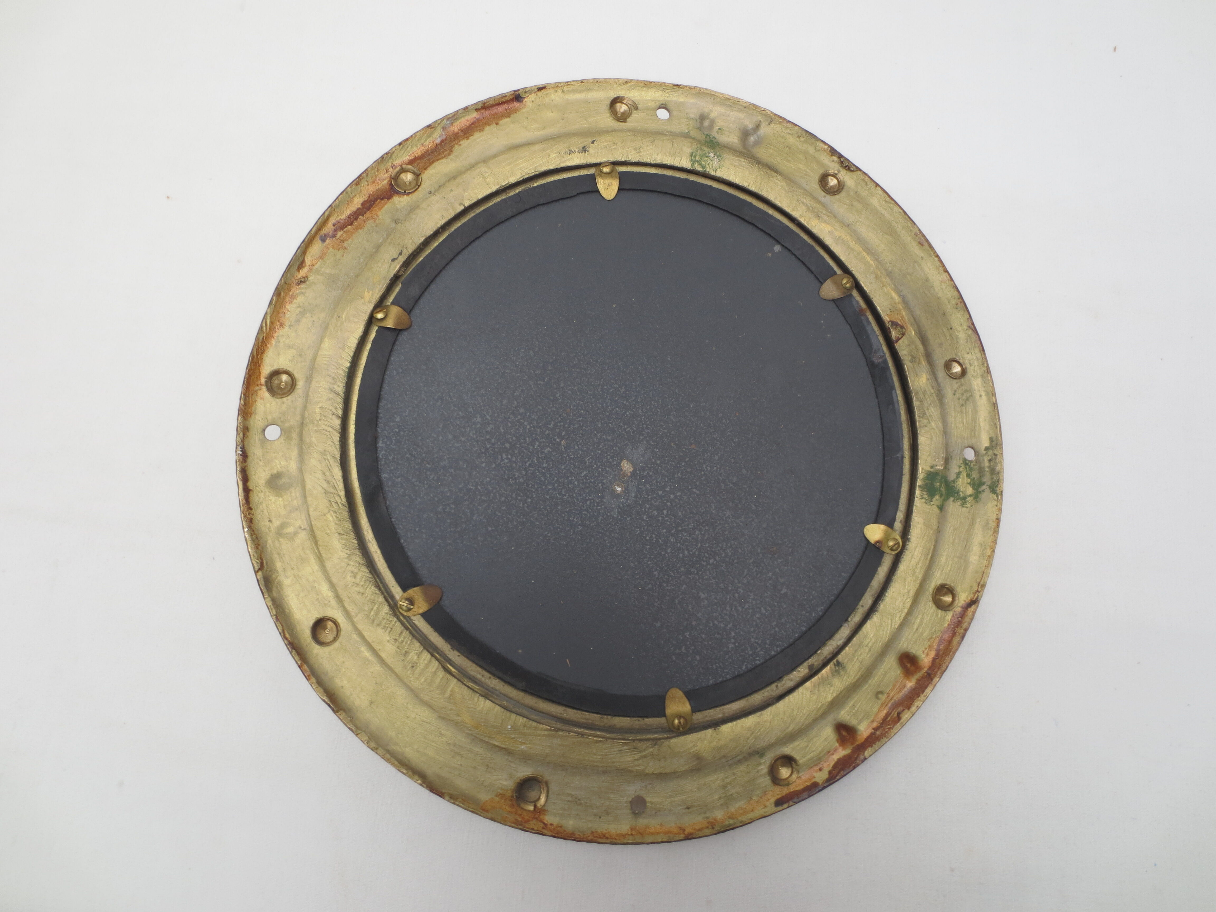 Mirror integrated into a brass navy porthole