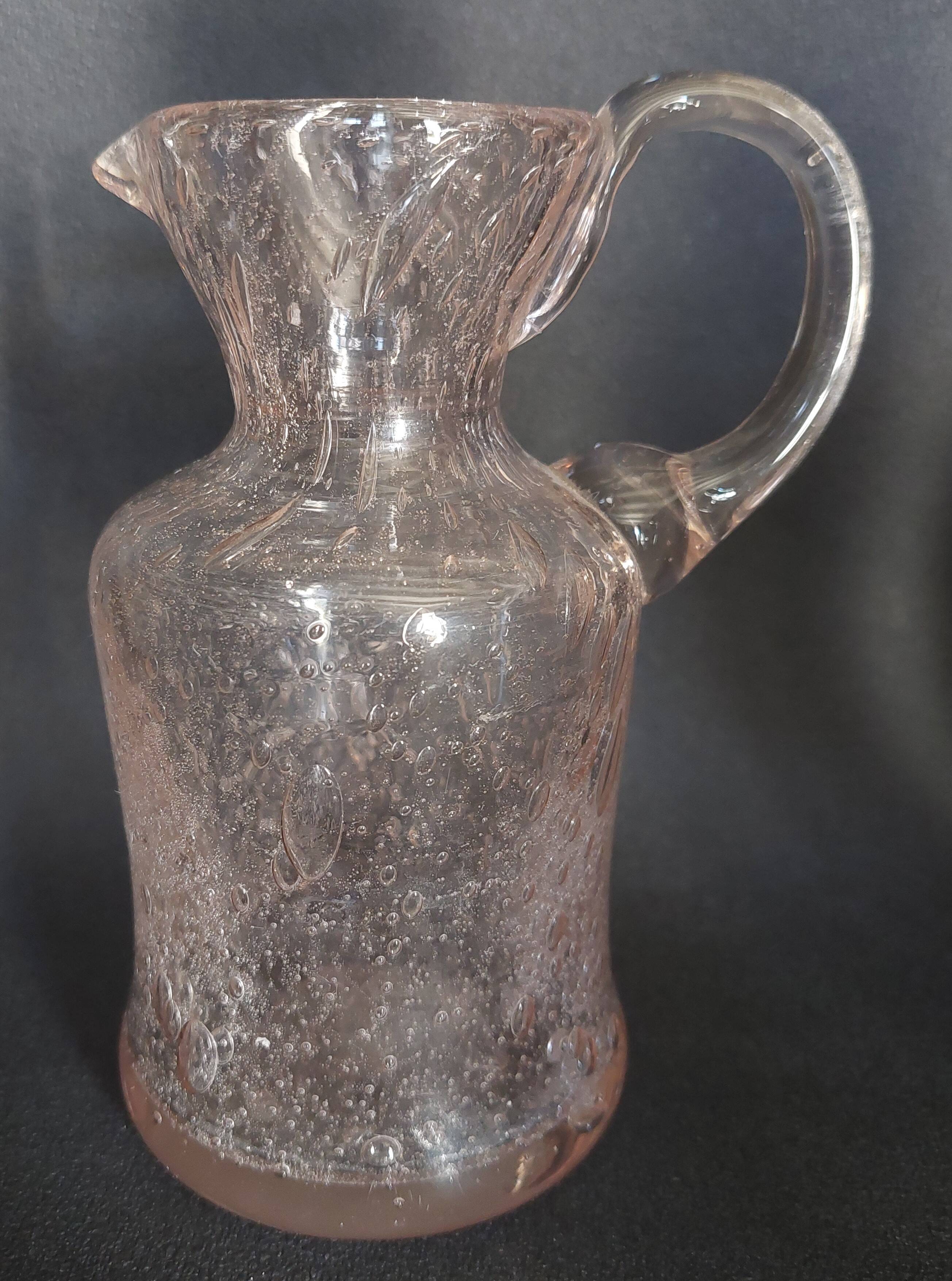 Small blown glass pitcher with bubbles from the 20th century.