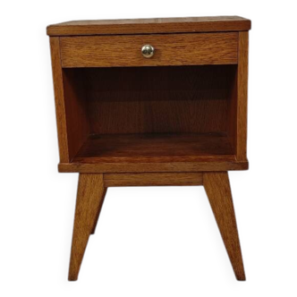 The bedside table with tapered legs.