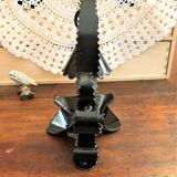 Handcrafted black wrought iron candle holder with its vintage extinguisher