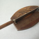 Old wooden bread cutter carved sheaf of wheat and metal deco kitchen Normandy countryside