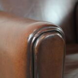 Sheepskin art deco design armchair with timeless and warm colours