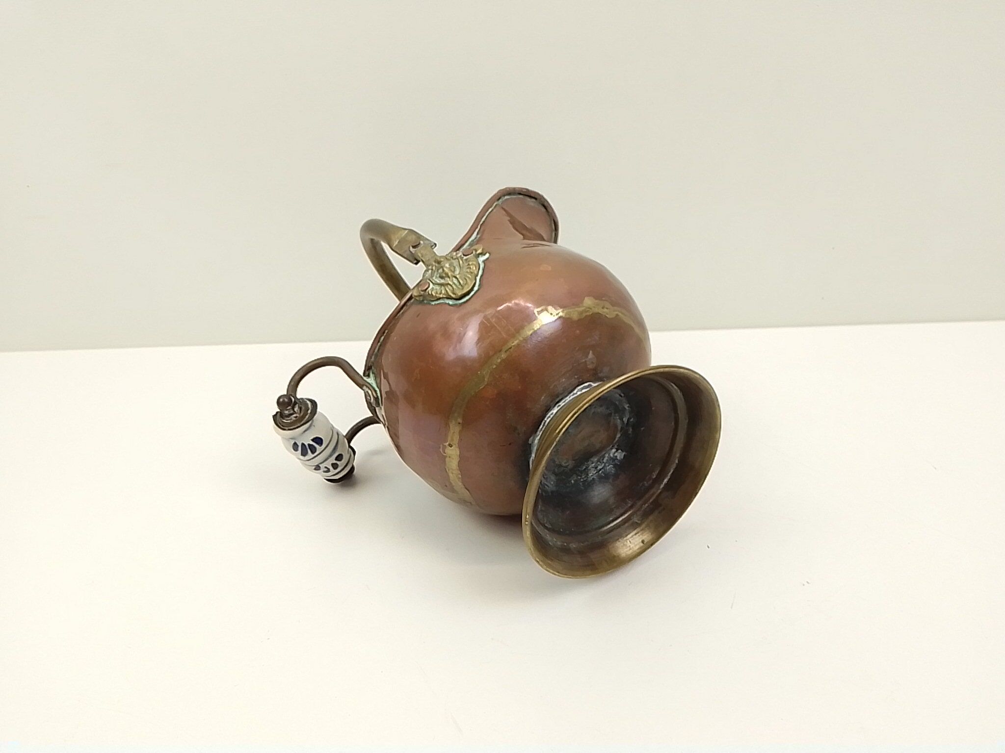 Copper pot cover and a pitcher-style brass handle