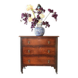 Antique oak chest of drawers on castors with brass handles and carved details