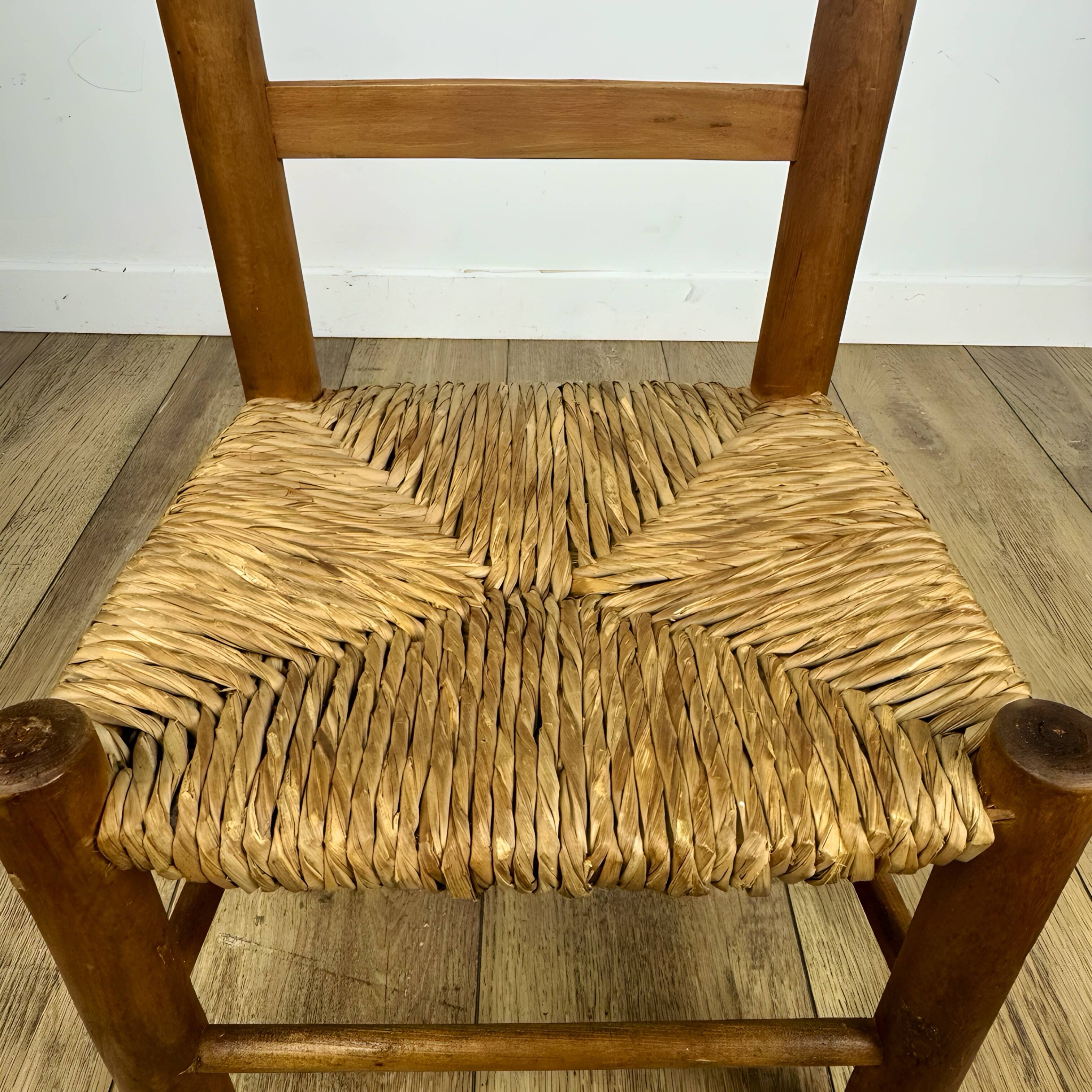 Pair of old wooden and straw children's chairs.