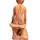 Painted plaster sculpture of a nude woman on a bench