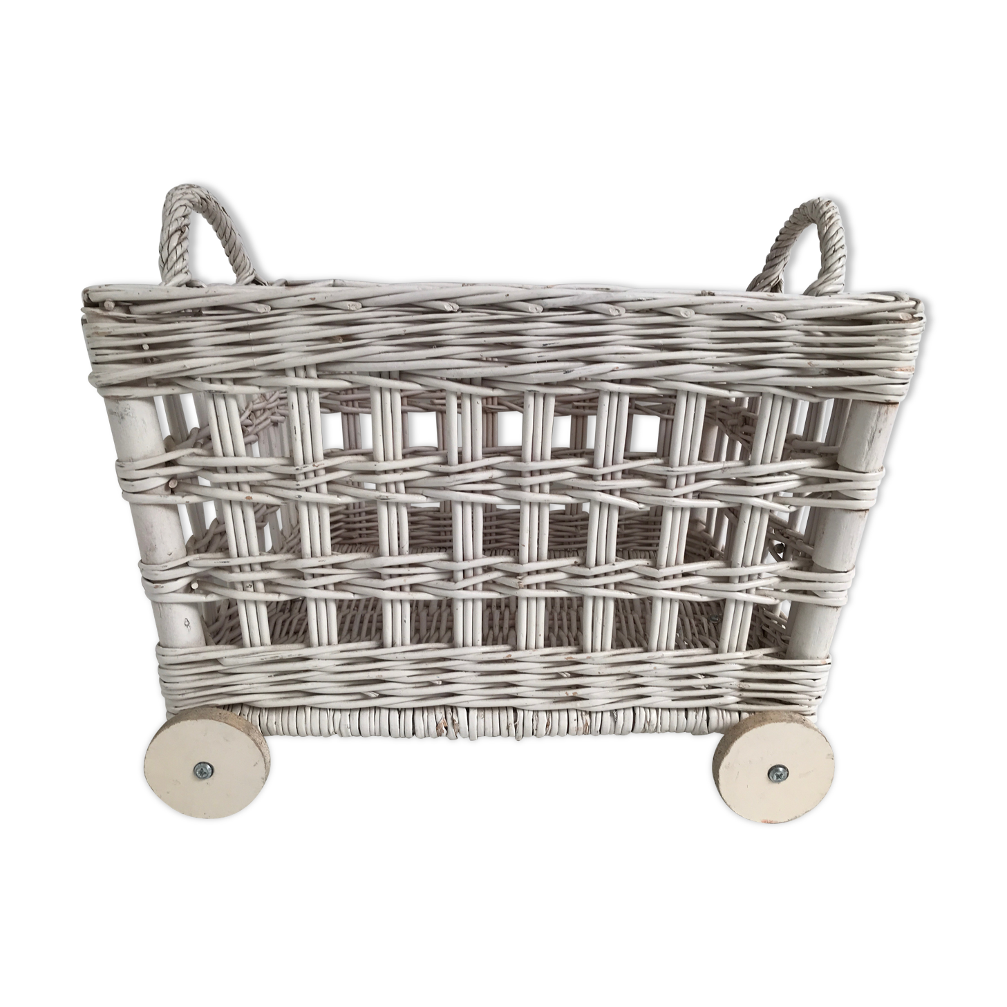 Wicker laundry basket on vintage wooden wheels