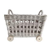 Wicker laundry basket on vintage wooden wheels