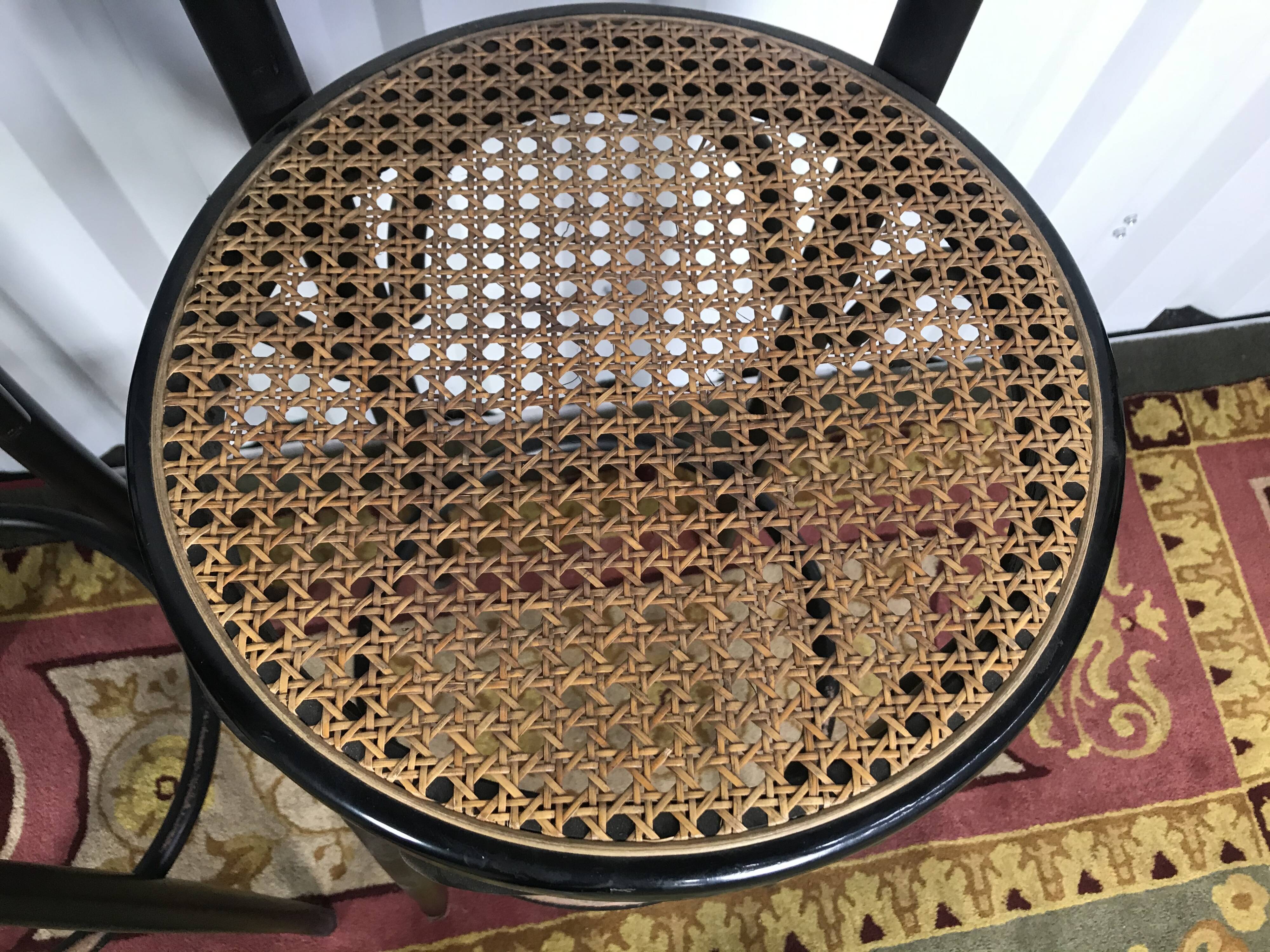 Suite de 4 tabourets de bar en cannage et bois noirci