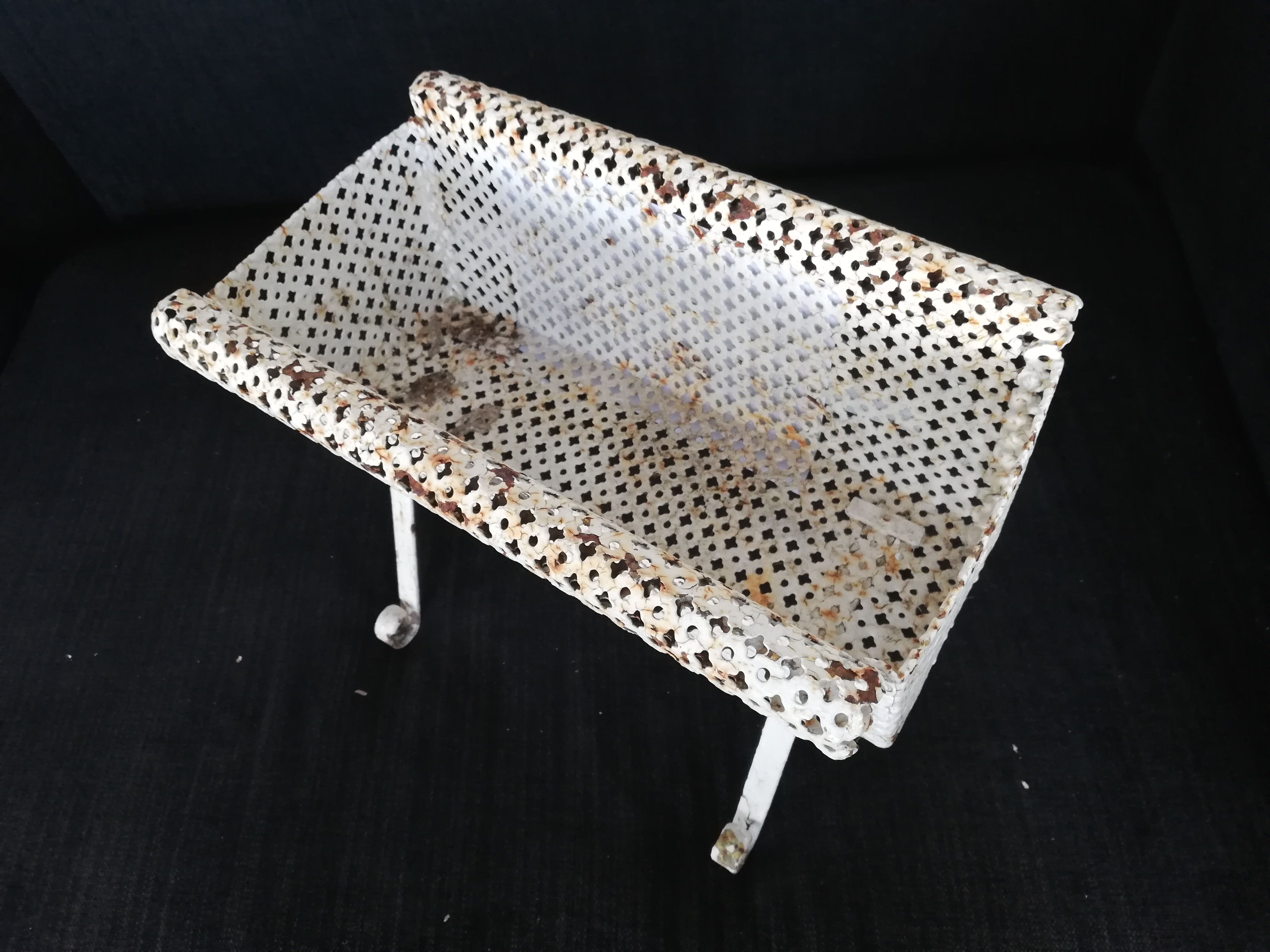 Wrought iron planter hides perforated sheet metal pot