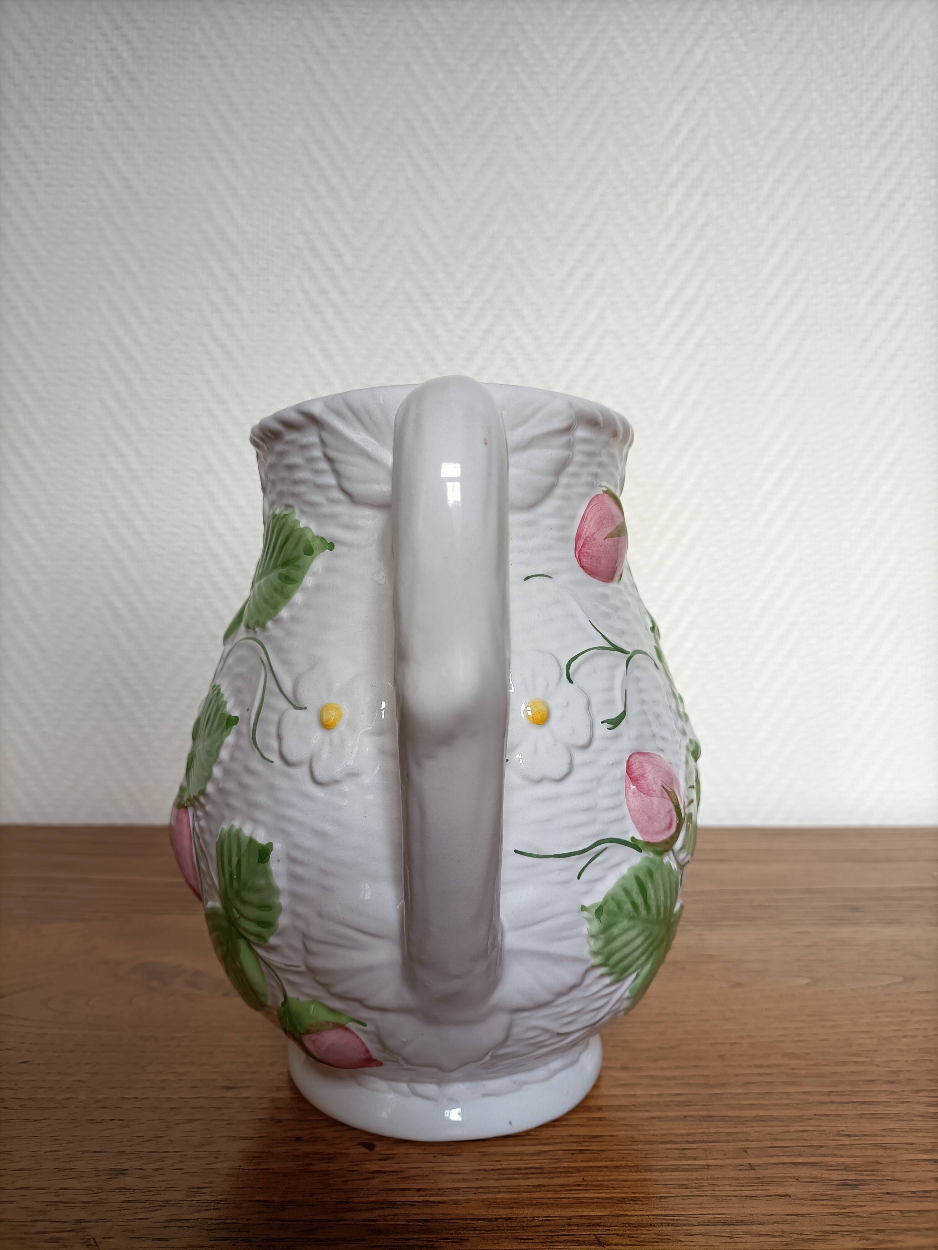 Barbotine pitcher with pastel flower decoration