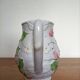 Barbotine pitcher with pastel flower decoration