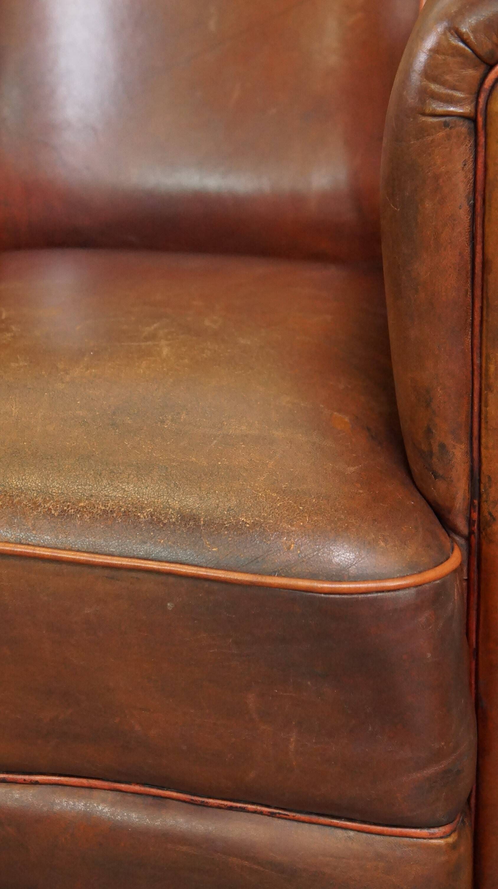 Neat, elegantly finished, cozy sheepskin club armchair with a fixed seat cushion