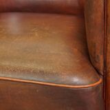 Neat, elegantly finished, cozy sheepskin club armchair with a fixed seat cushion