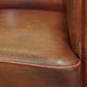 Neat, elegantly finished, cozy sheepskin club armchair with a fixed seat cushion