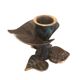 Patinated green brass candlestick with foliage decoration.