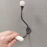 Coat hooks made of galvanized brass and raw white porcelain
