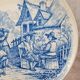 Old advertising plate with blue decoration after Teniers – 100,000 Shirts Paris