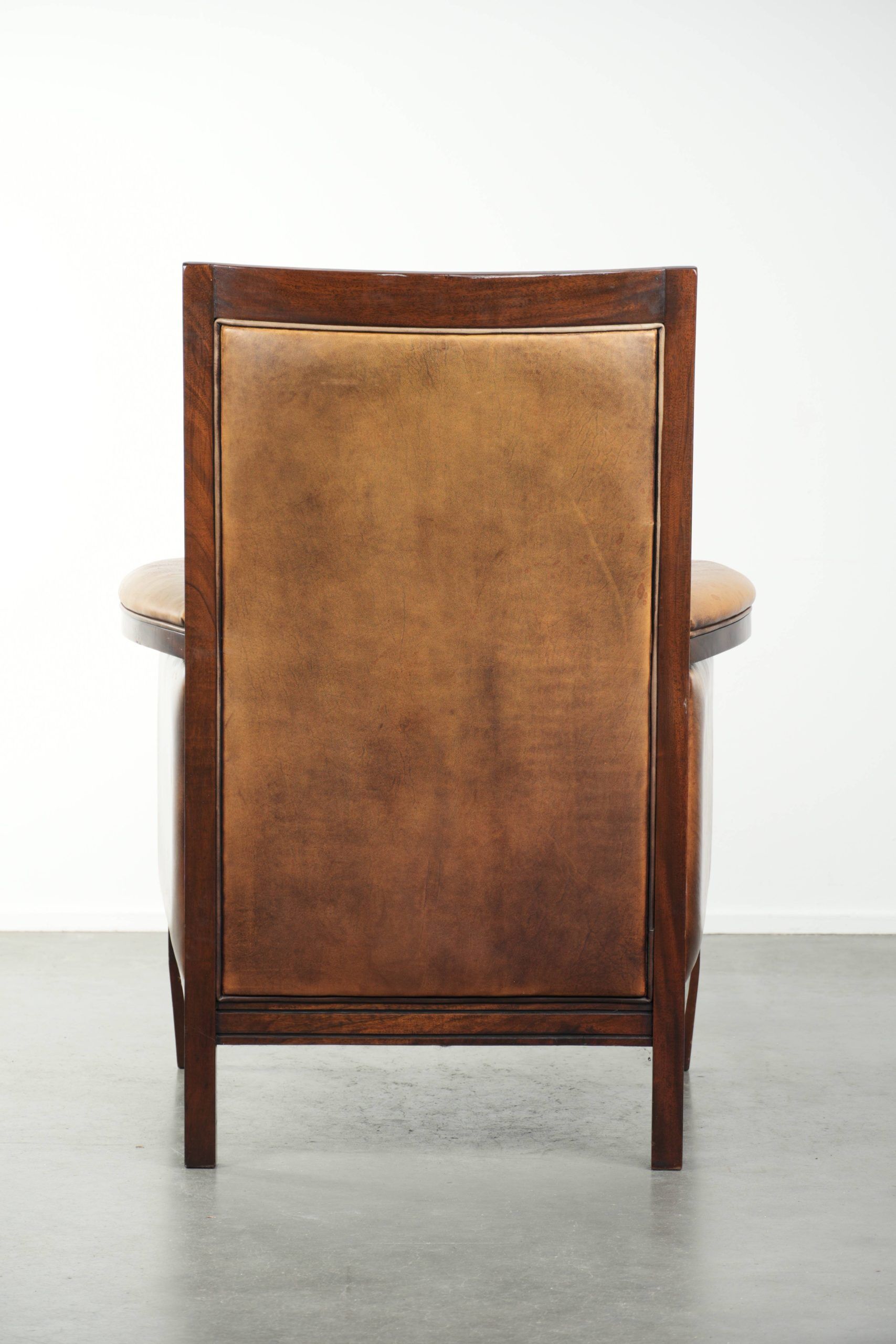 Cognac-coloured Art Deco design armchair made of sheepskin with a high back