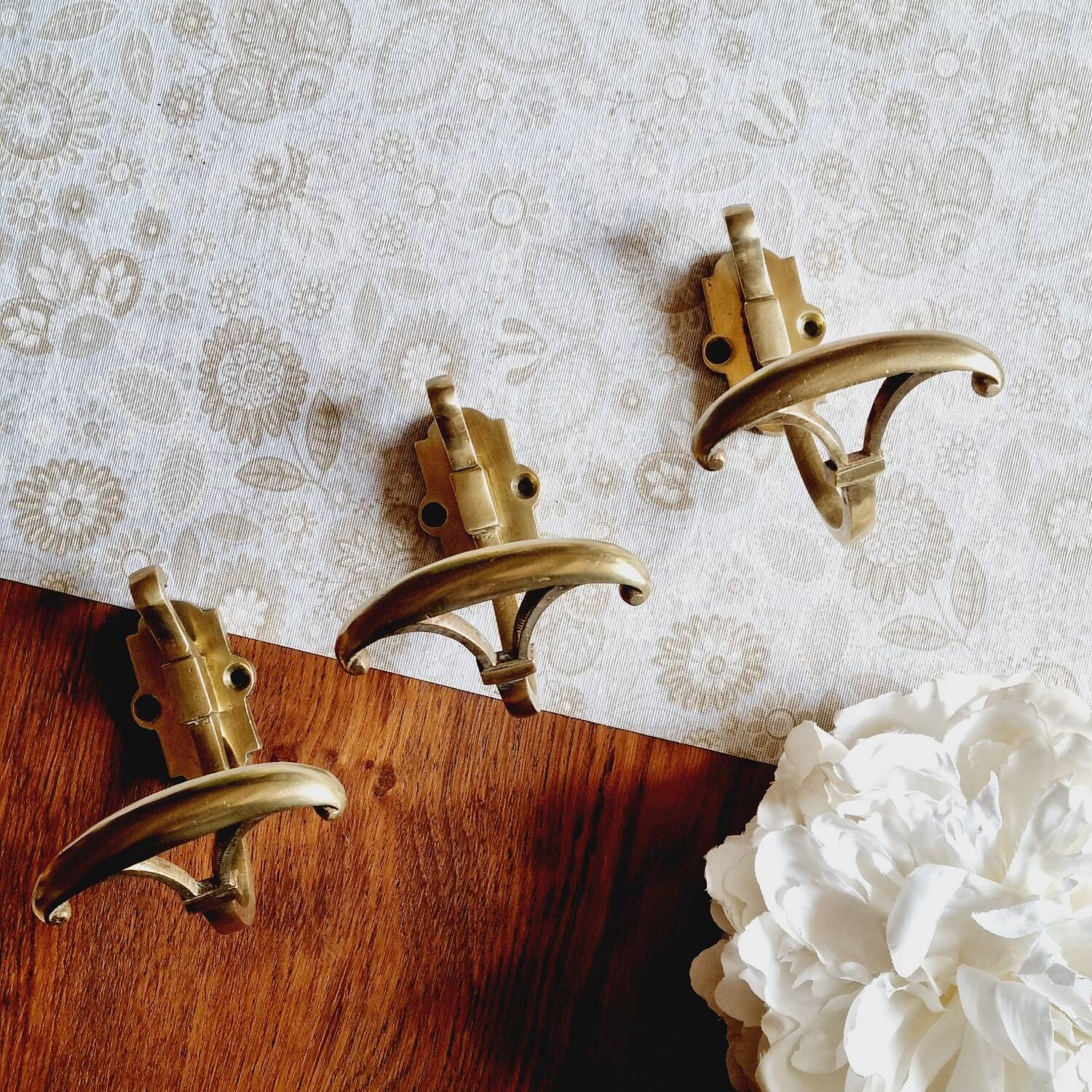 Trio of brass coat hooks or coat racks
