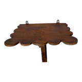 Antique wall shelf with a scalloped edge.