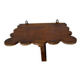 Antique wall shelf with a notched top.