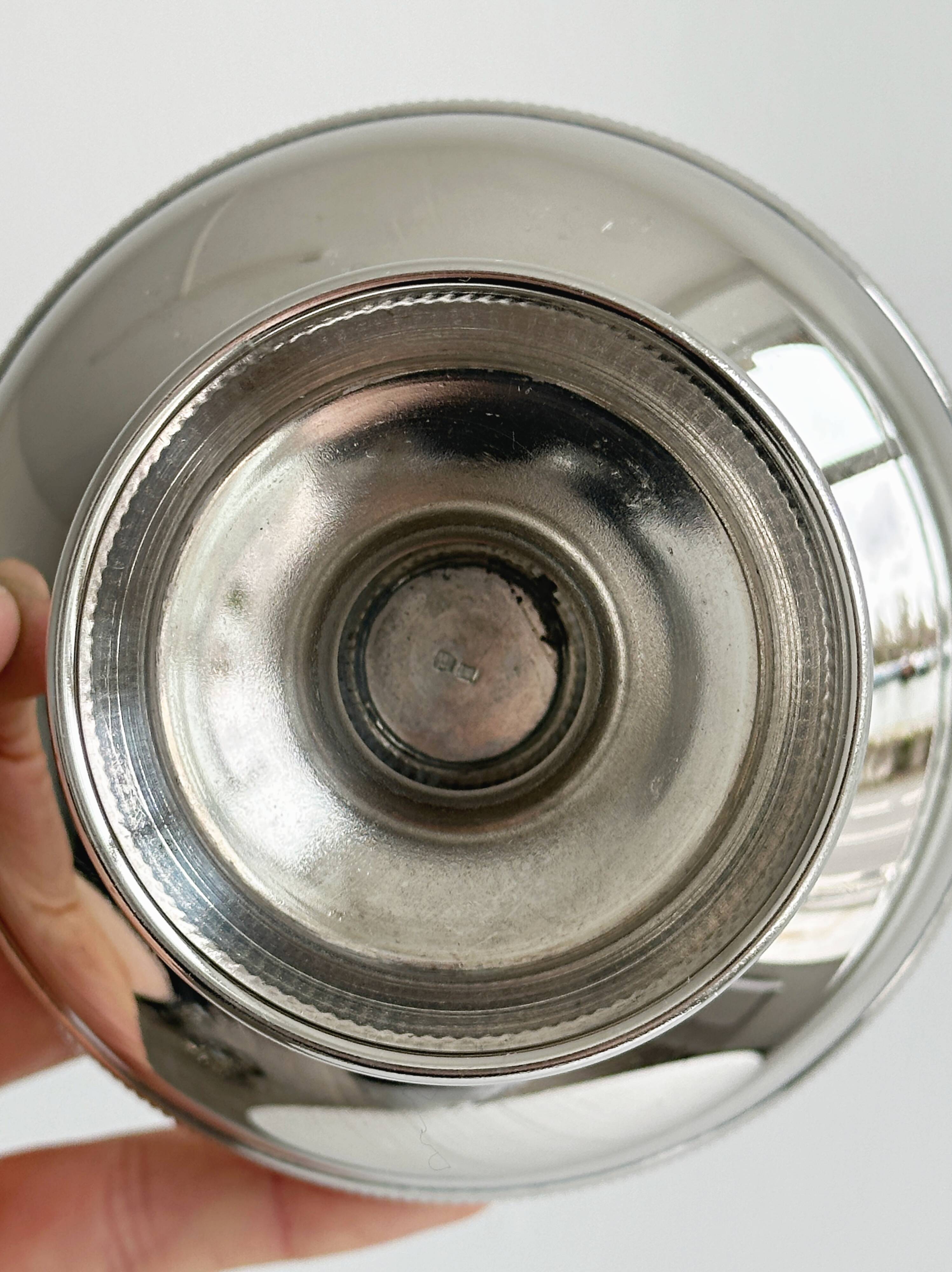 Small silver-plated metal bowl on a stand.