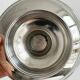 Small silver-plated metal bowl on a stand.