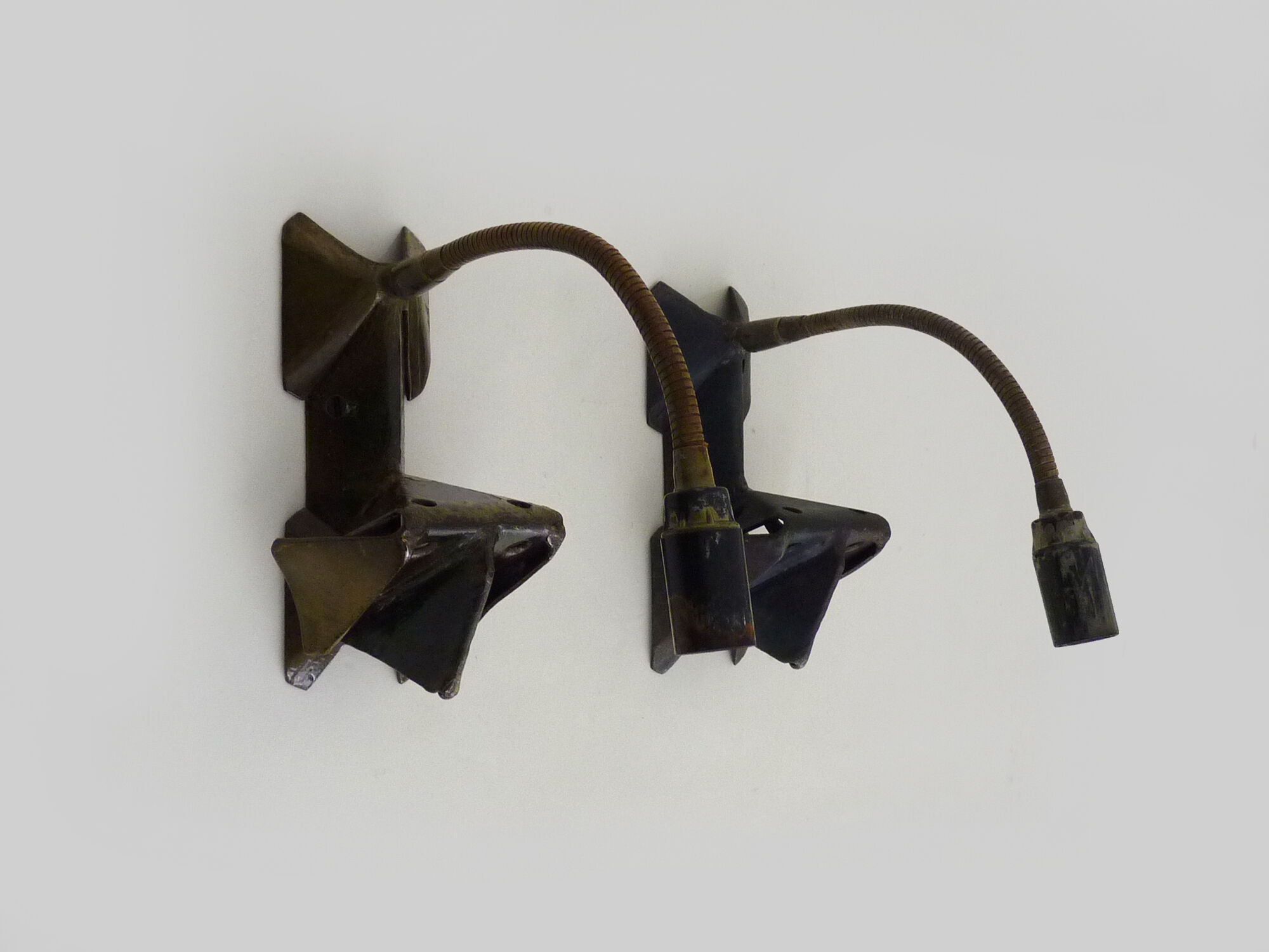 Pair of cast iron wall sconces with articulated arm, dog shape. Vintage