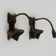 Pair of cast iron wall sconces with articulated arm, dog shape. Vintage
