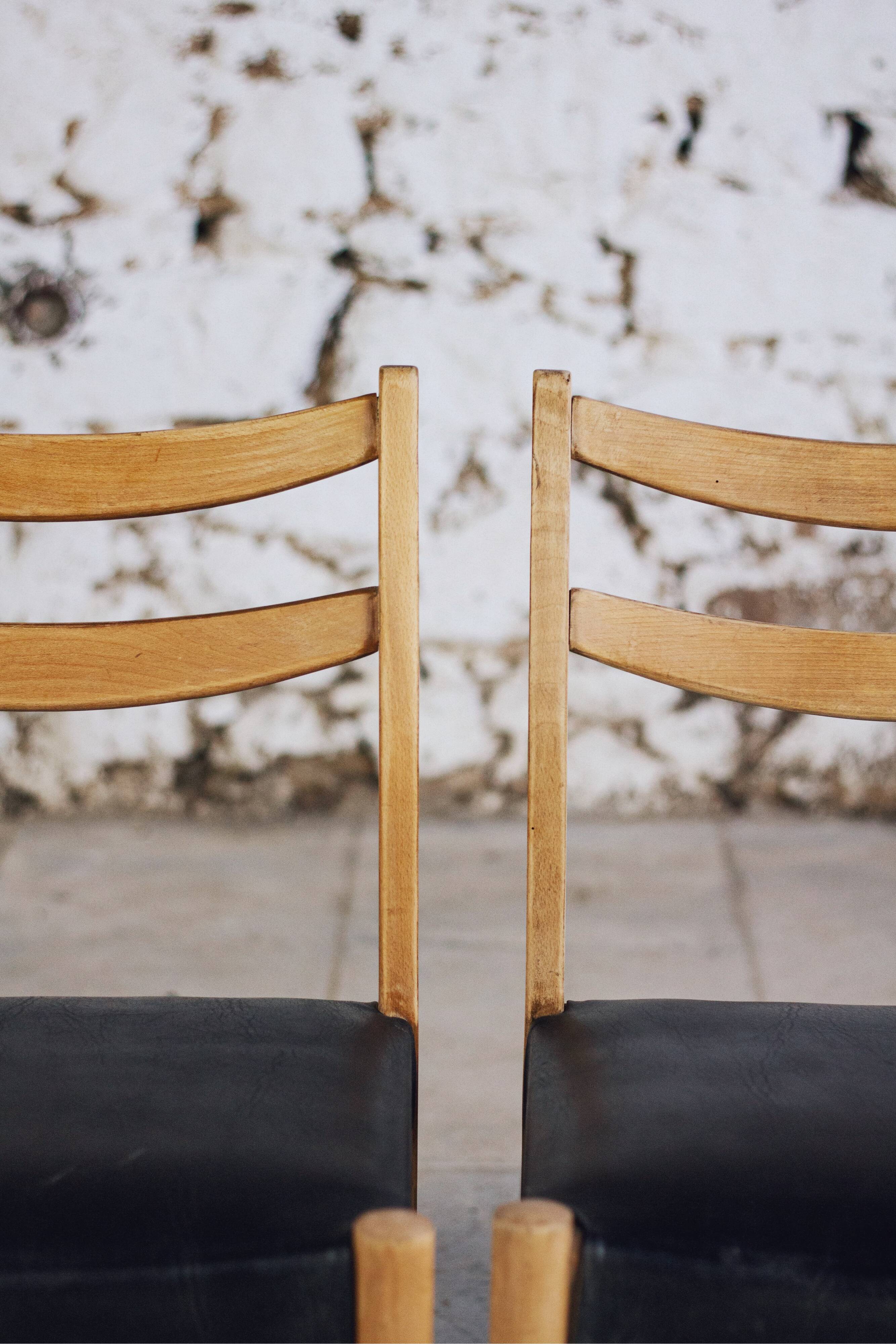 Pair of Scandinavian chairs in teak and faux leather, 1960.
