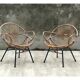 Pair of rattan shell chairs with metallic feet