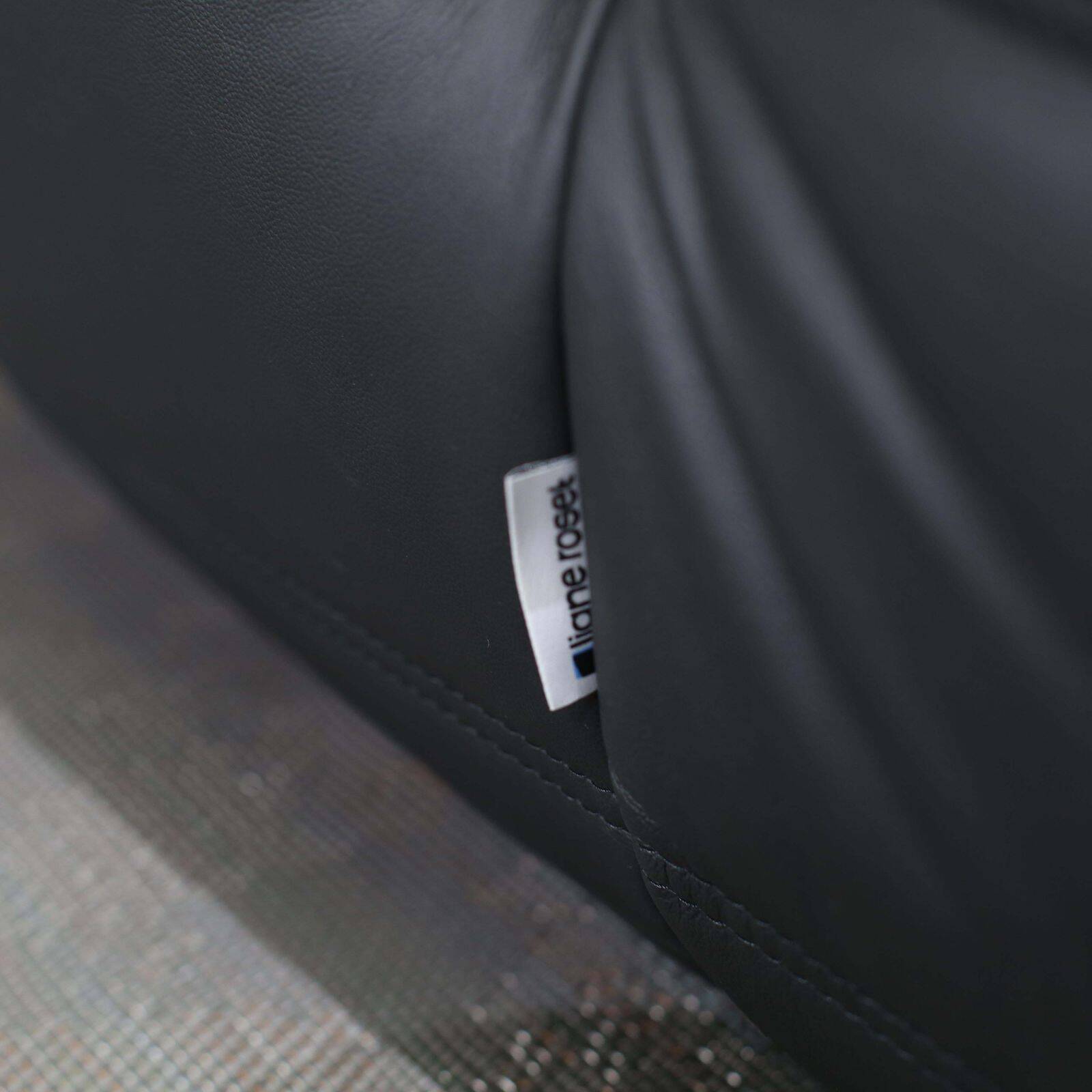 Togo armchair and footrest in black leather by Ligne Roset, designed by Michel Ducaroy.