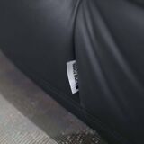 Togo armchair and footrest in black leather by Ligne Roset, designed by Michel Ducaroy.