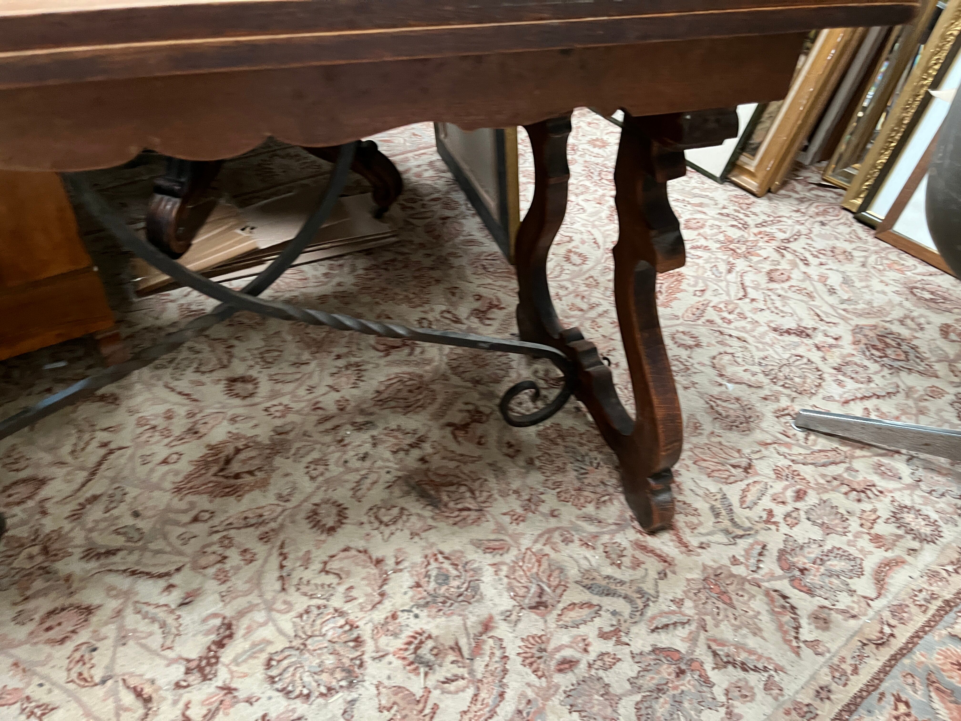 Spanish style table in carved wood and wrought iron