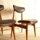 Pair of modernist Scandinavian chairs in teak and black faux leather.