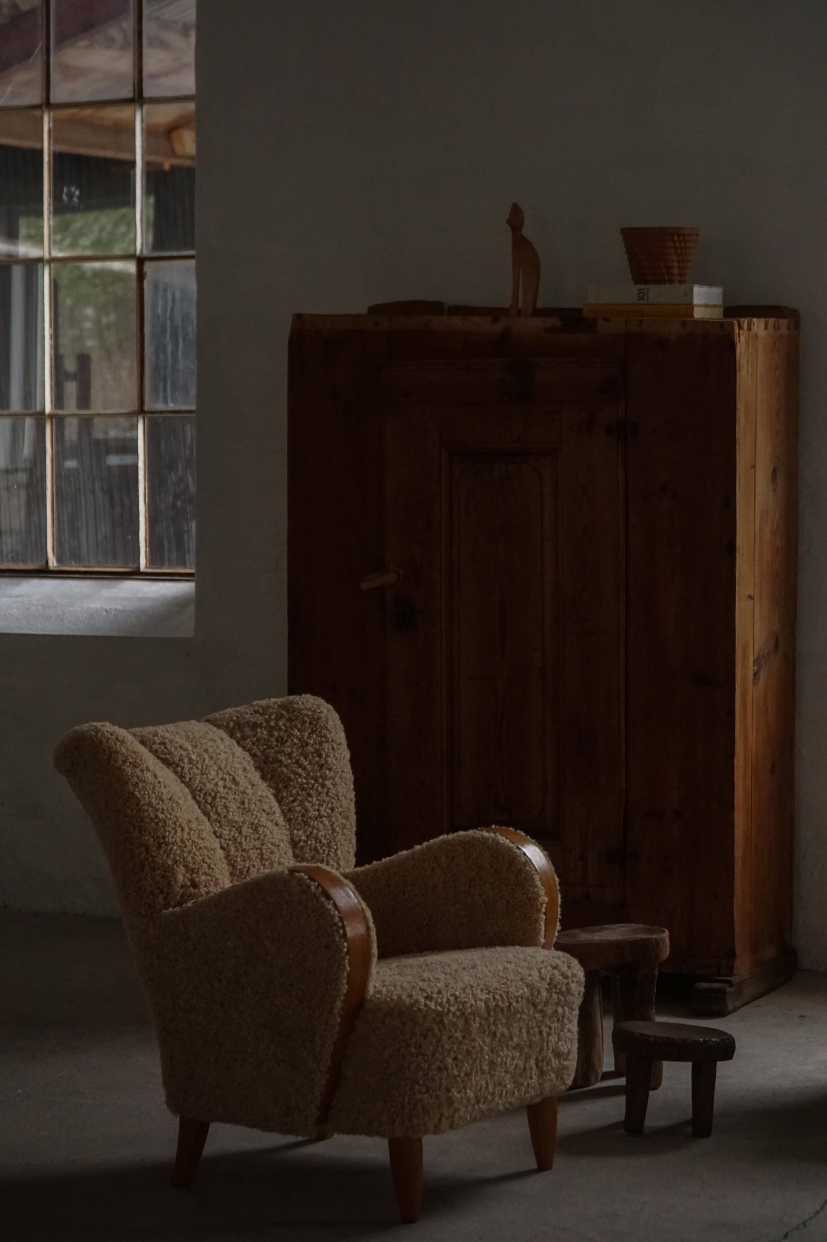 Pair of Danish Art Deco modern lounge chairs in sheepskin with lambswool and elm, 1940s.