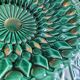 Large pierced earthenware fruit bowl glazed in green and gold.