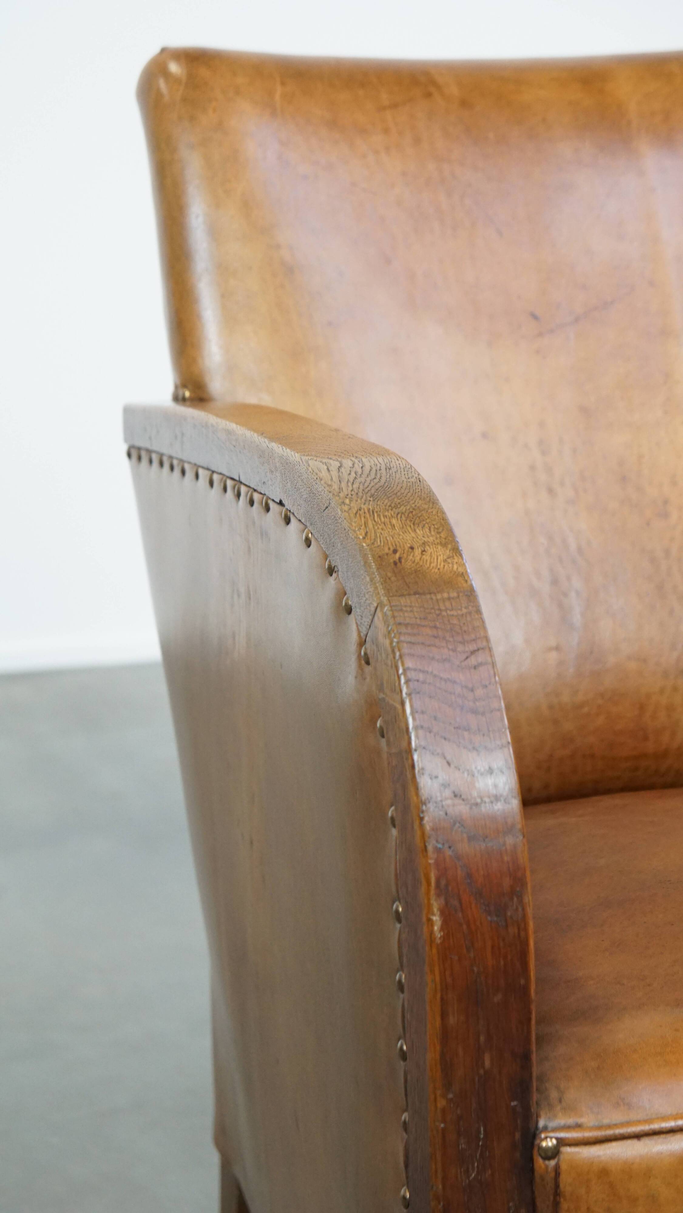 Cognac-colored sheepskin and wooden Art Deco design armchair