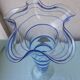 Glass vase on a pedestal with a blue trim.