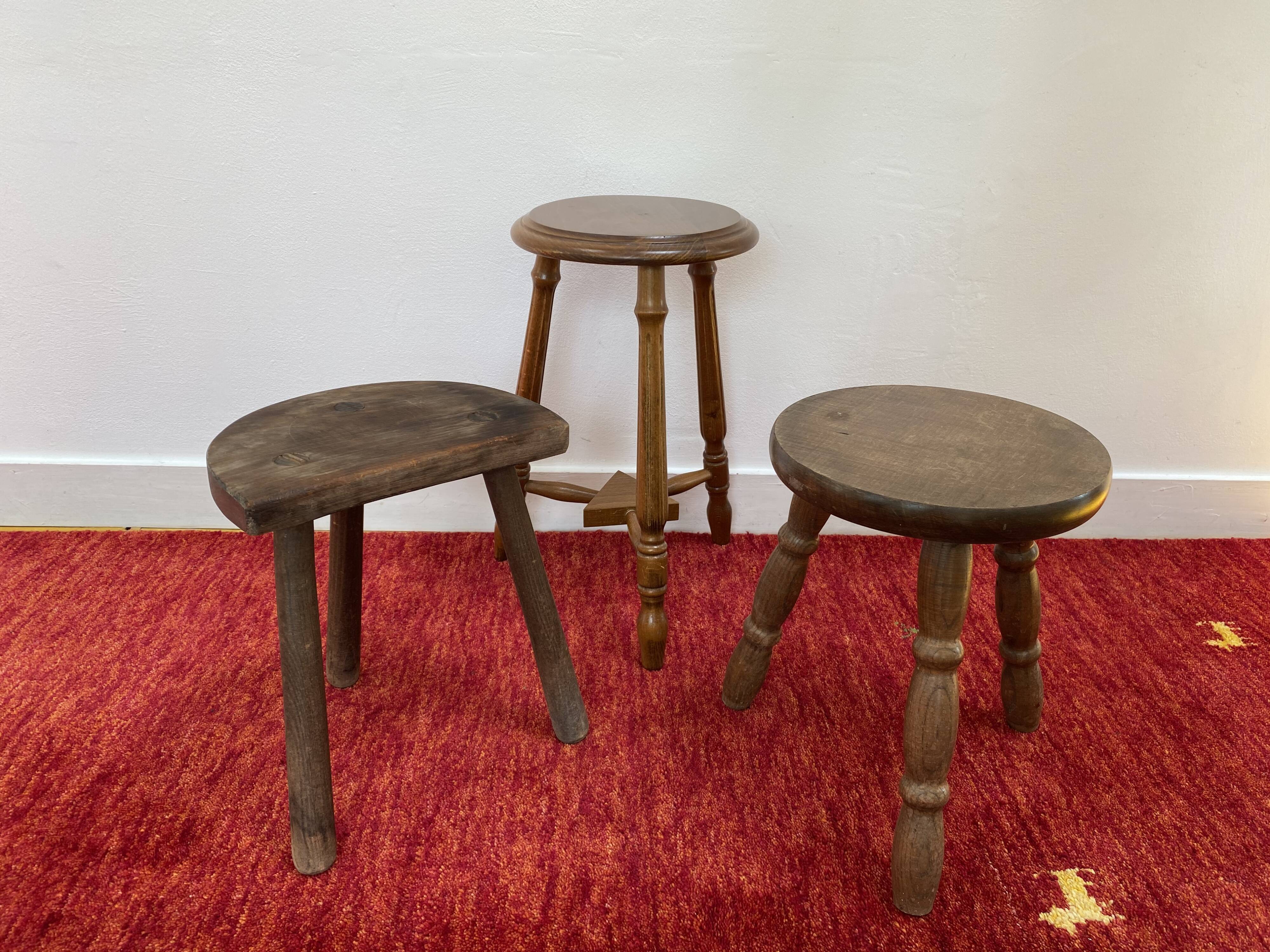 Old wooden tripod stool with ball feet