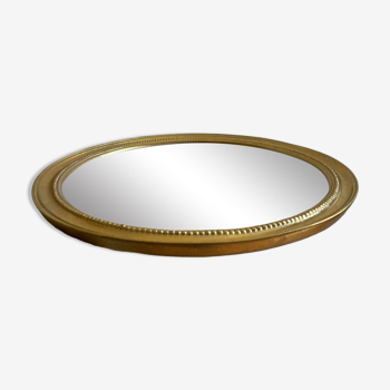 Round mirror with golden wood frame