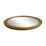 Round mirror with golden wood frame