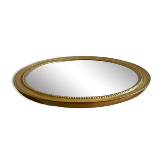 Round mirror with golden wood frame