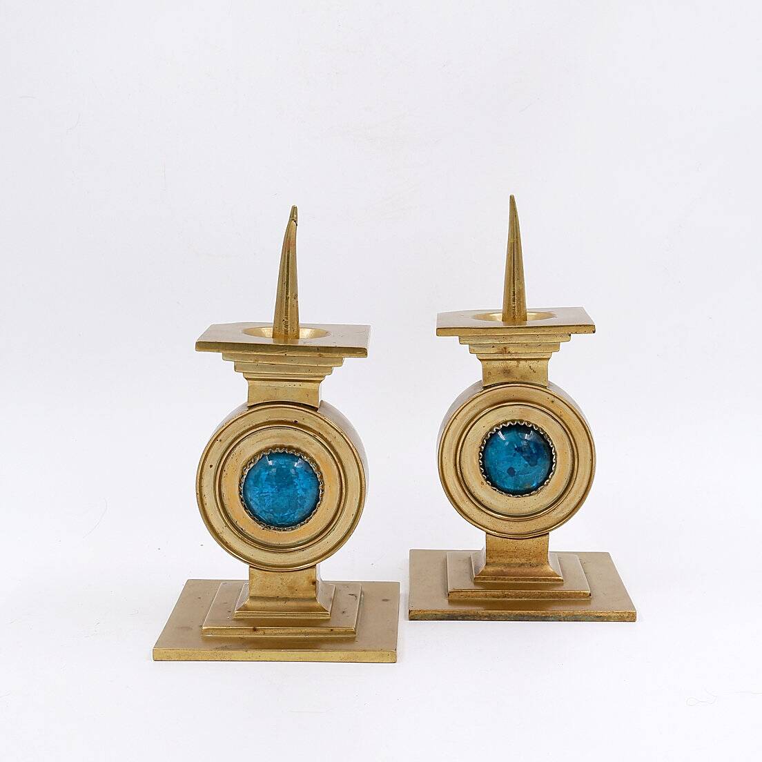Pair of brass candlesticks decorated with a blue stone inlaid in the center