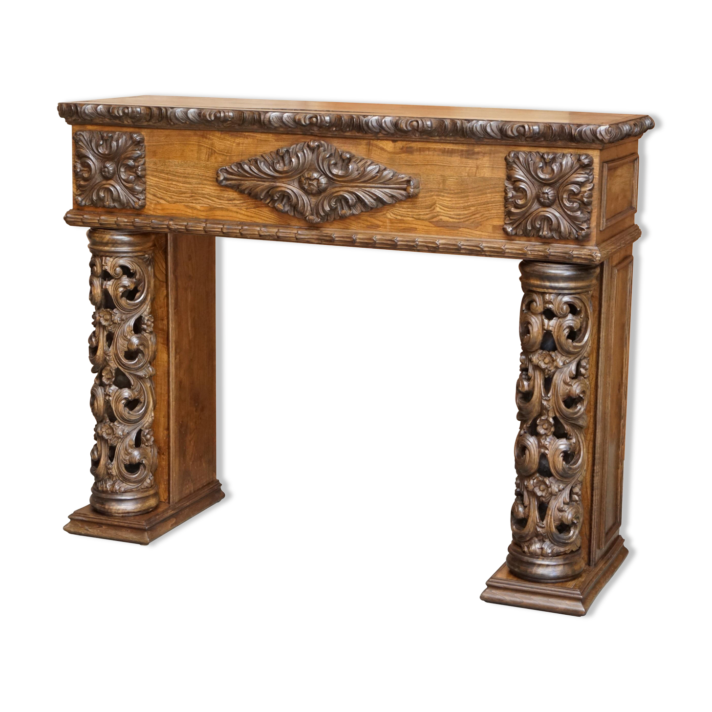Antique fireplace from around 1880 in solid hand-carved elm with openwork columns.